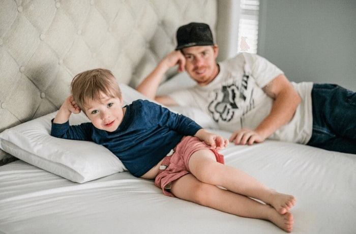 Father and son lying on bed